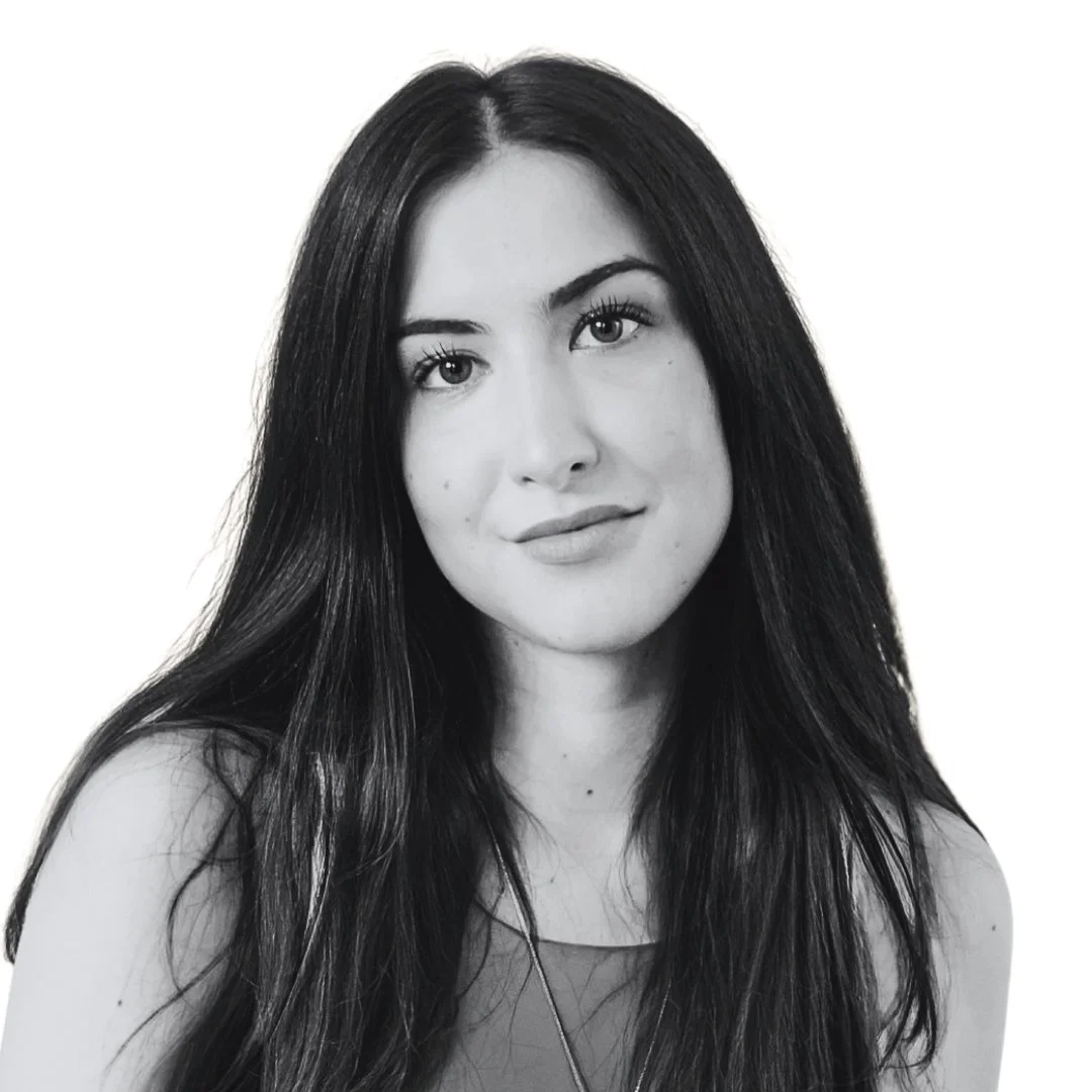 Confident woman in monochrome, conveying expertise in luxury real estate marketing and brand strategy.